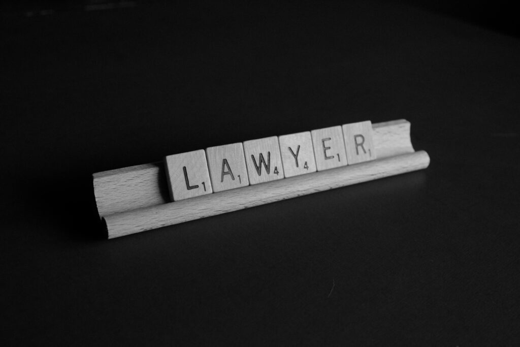Scrabble tiles spelling out lawyer. personal injury defense lawyer